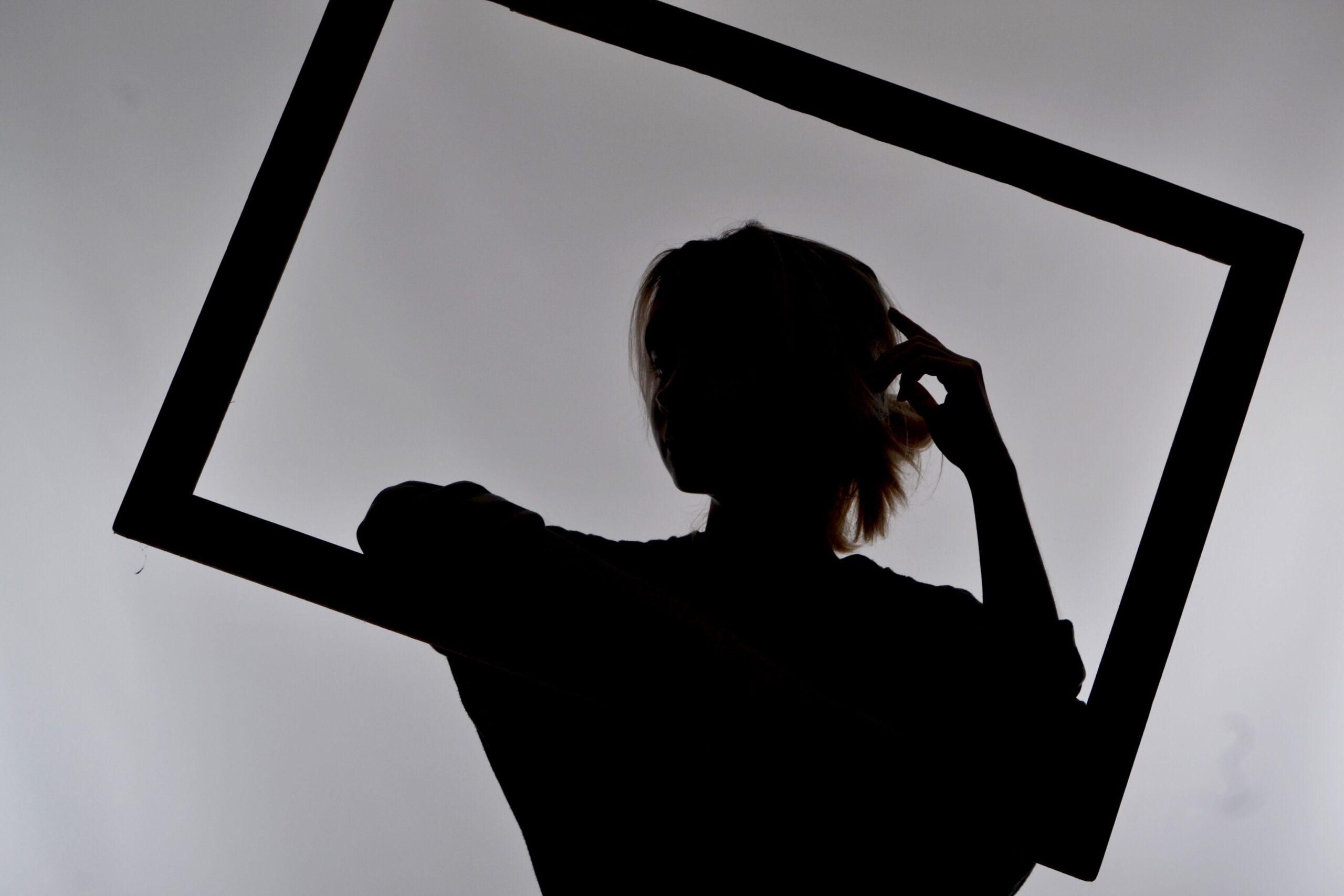 Silhouette of a woman standing in a picture frame